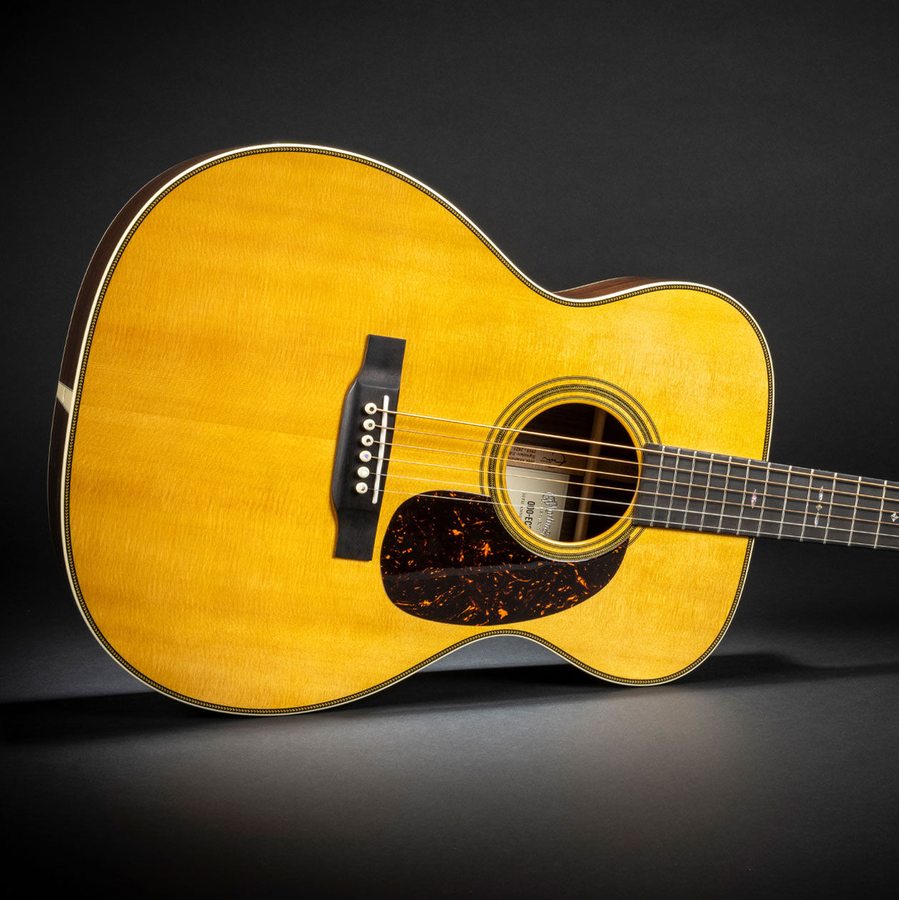Photo of an acoustic guitar on a black background