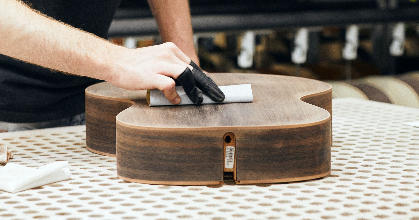 Person working on the body of a guitar