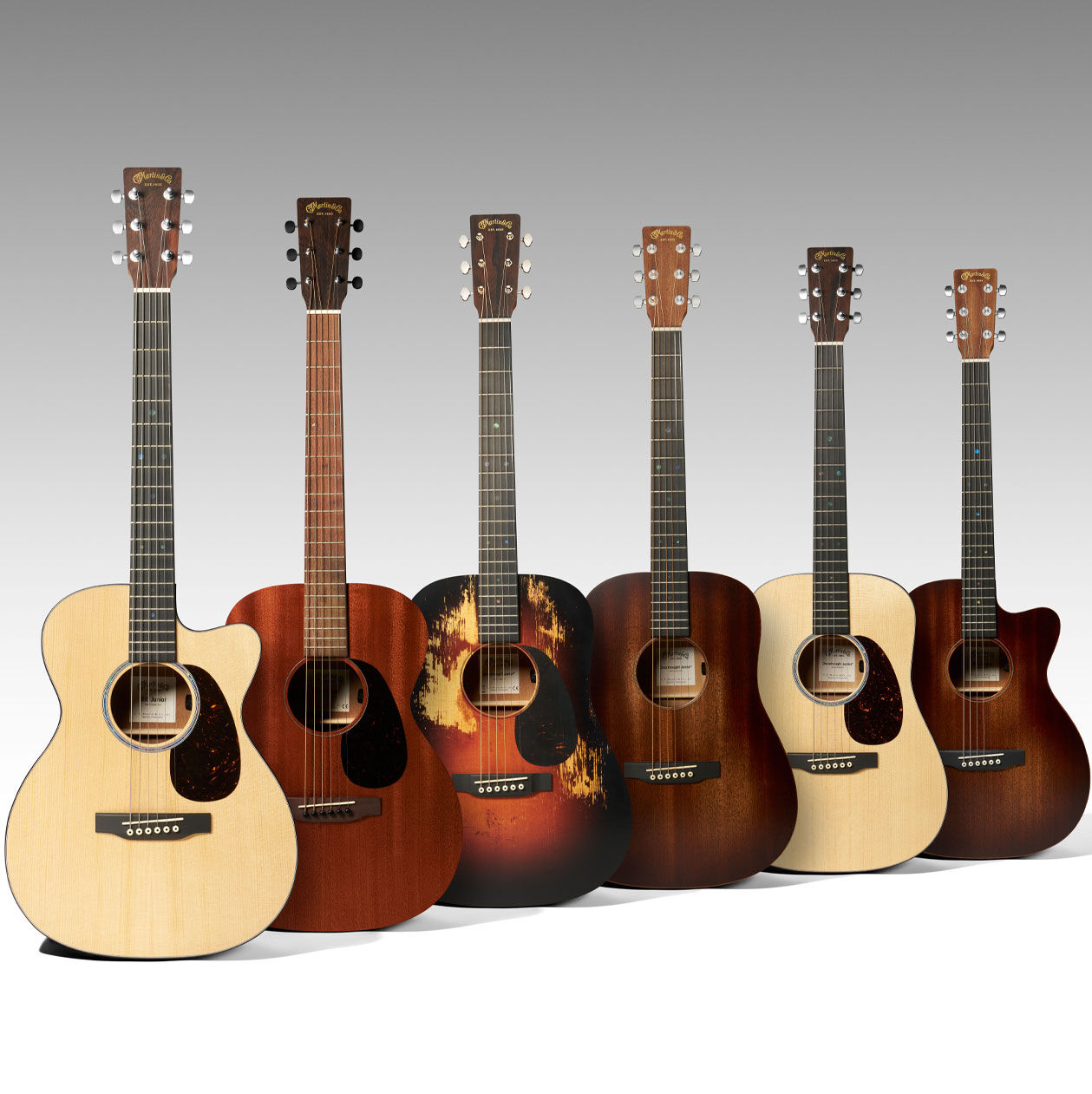 A group of six Martin guitars in descending sizes