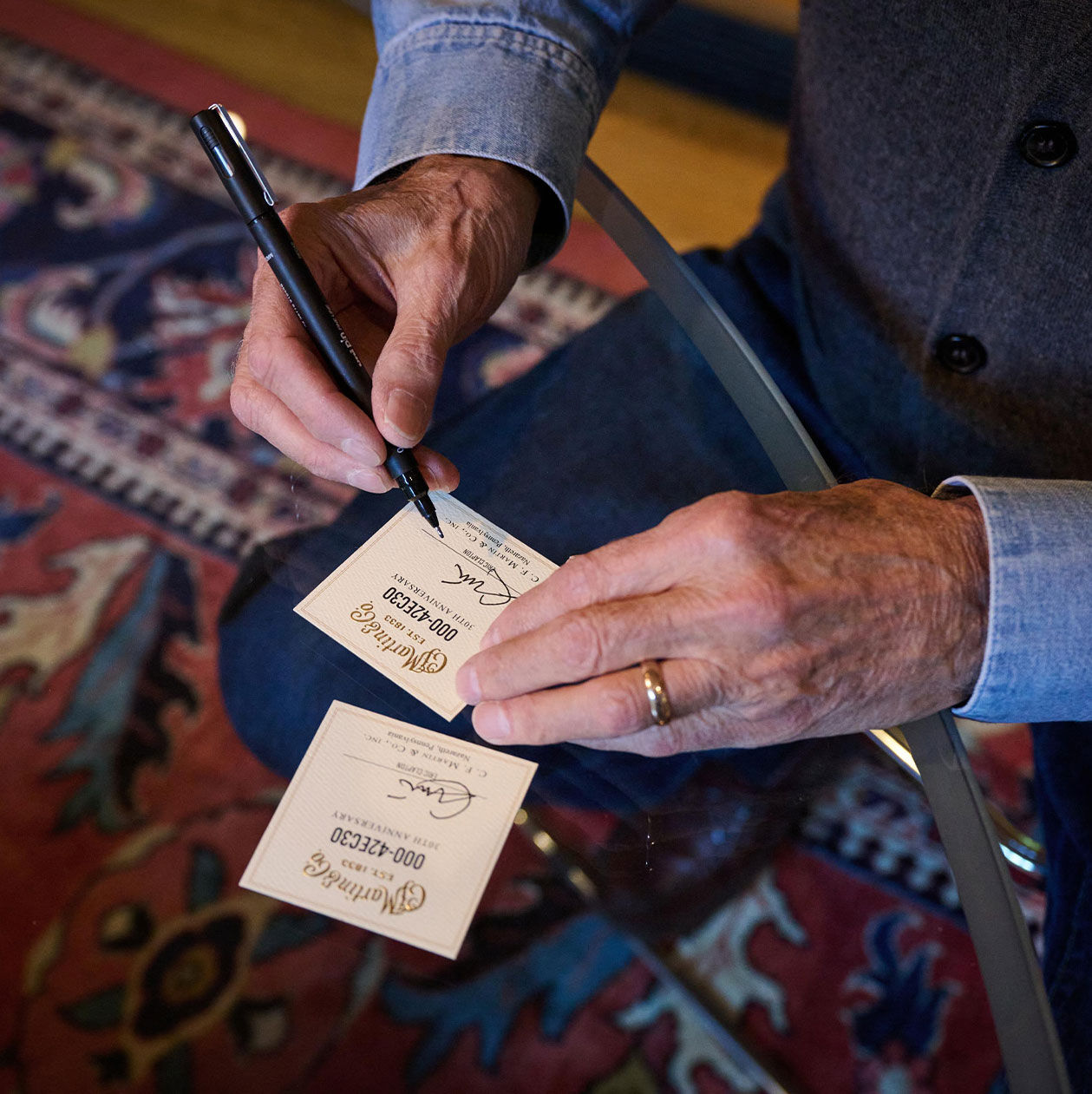 Eric Clapton signing labels for his acoustic guitars