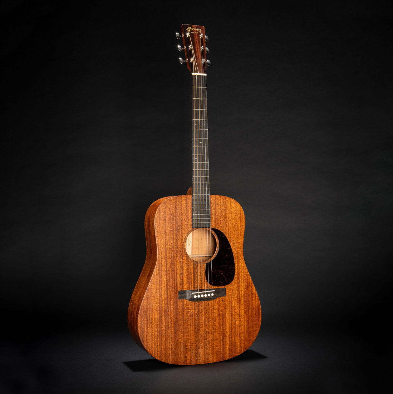 The Martin D-17 acoustic guitar on a black background