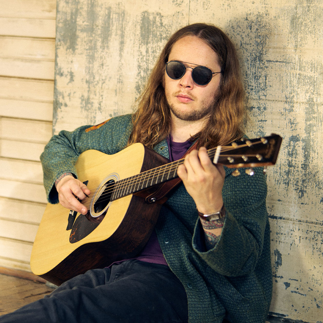 Billy Strings playing an acoustic guitar