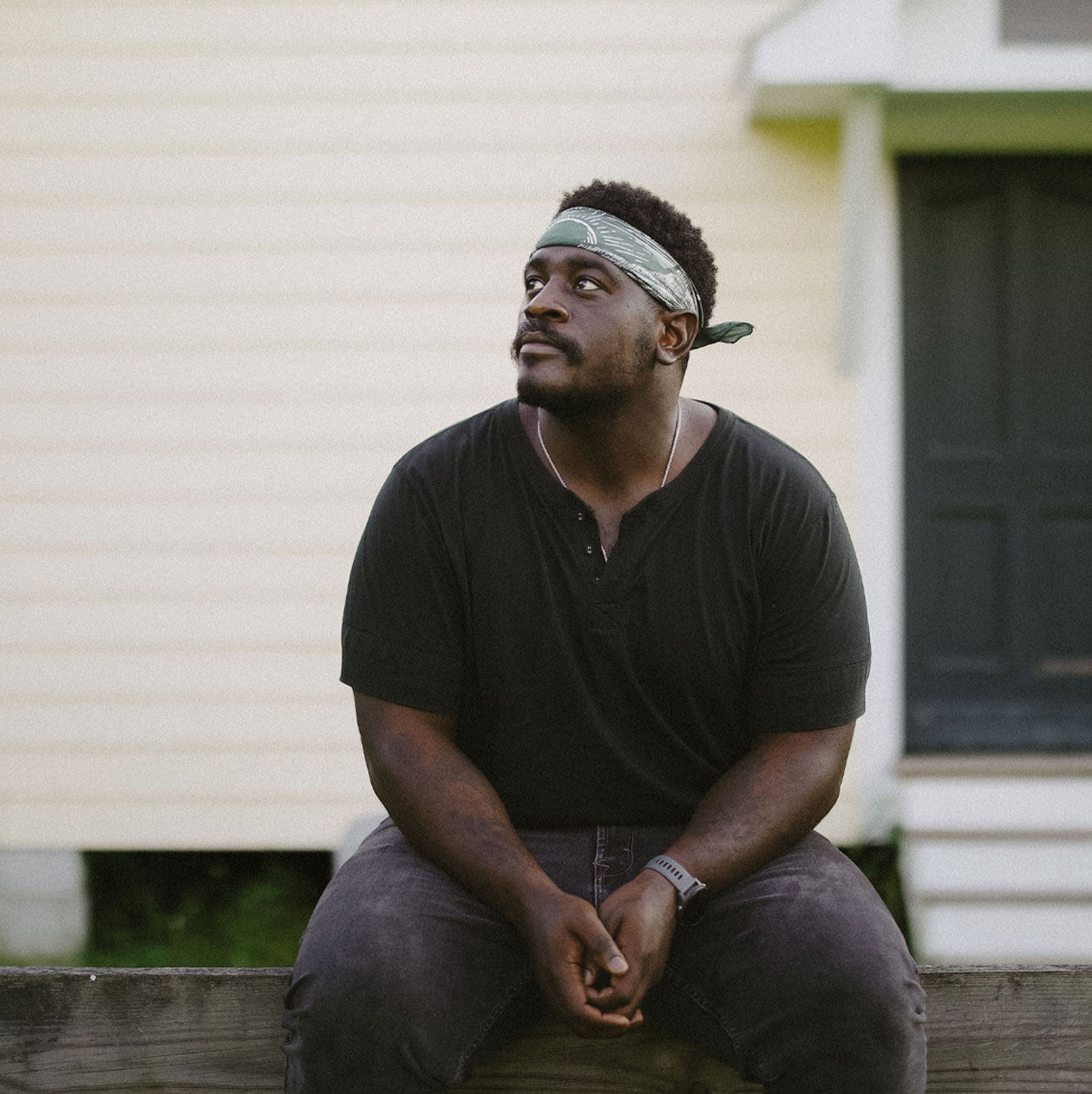 Photo of Kashus Culpepper sitting on a ledge.