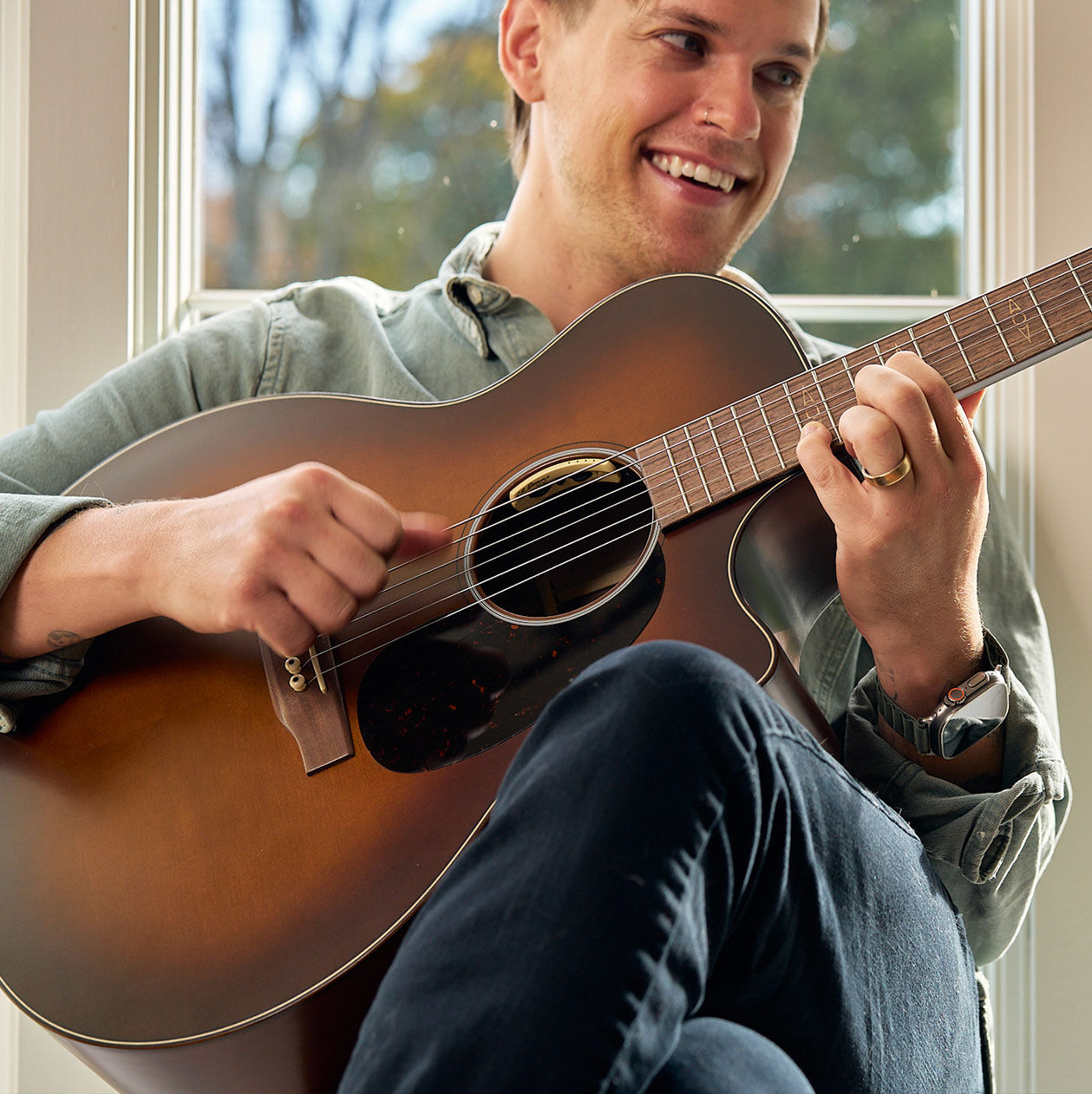Person playing an acoustic guitar