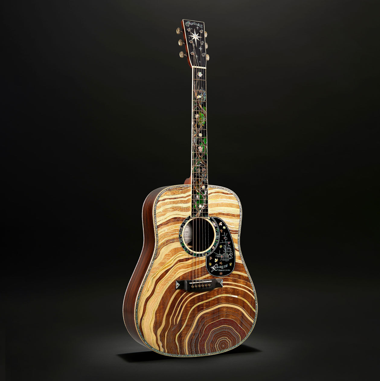 The Martin D-300 milestone guitar on a black background