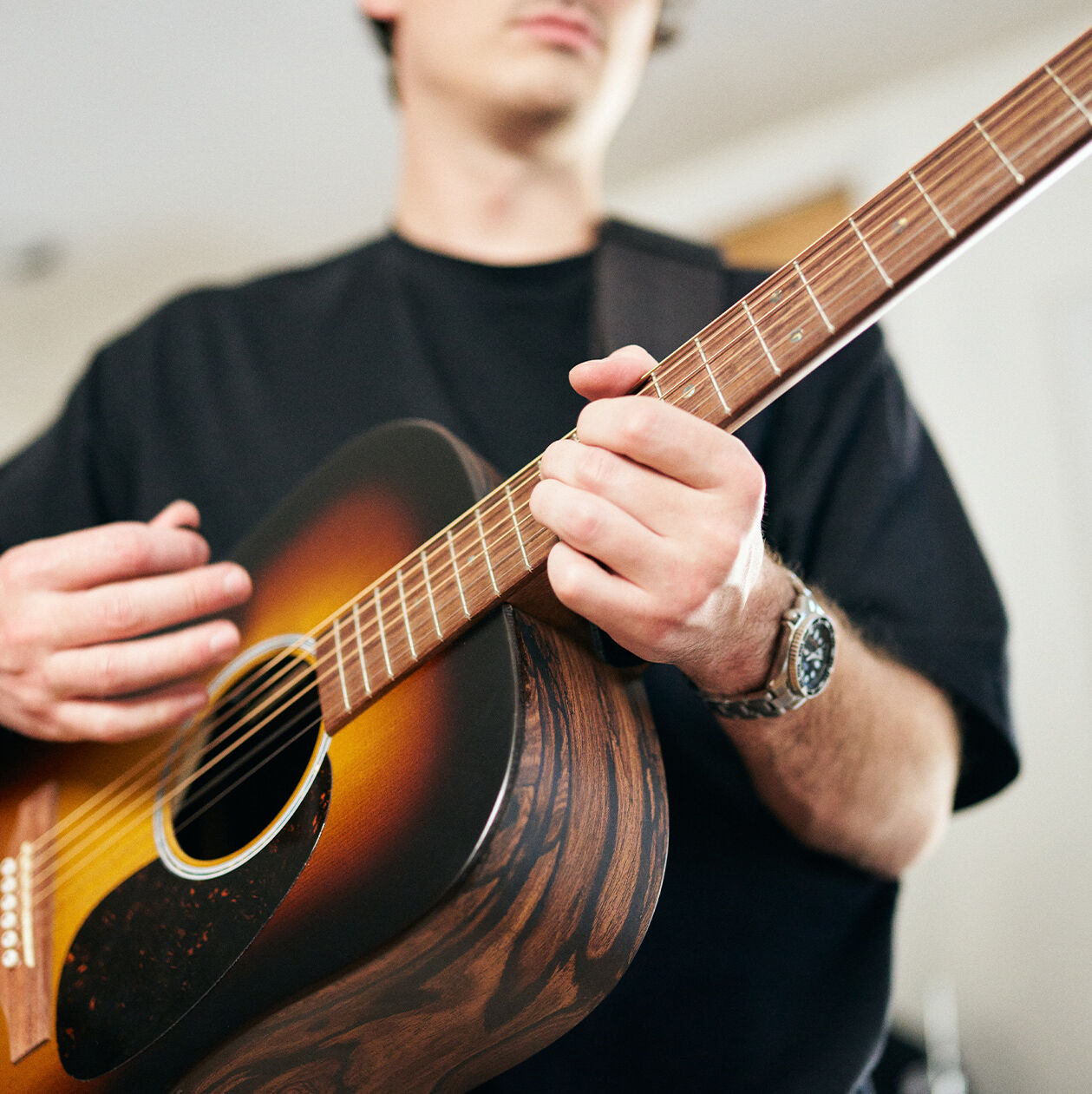 Person playing an acoustic guitar