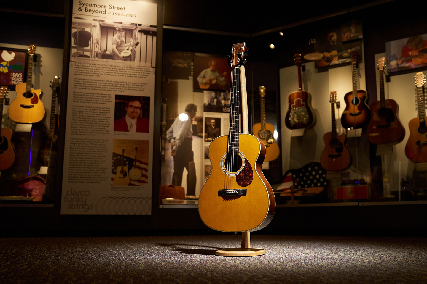 The OM-JM John Mayer martin sitting on a stand in the Martin Museum