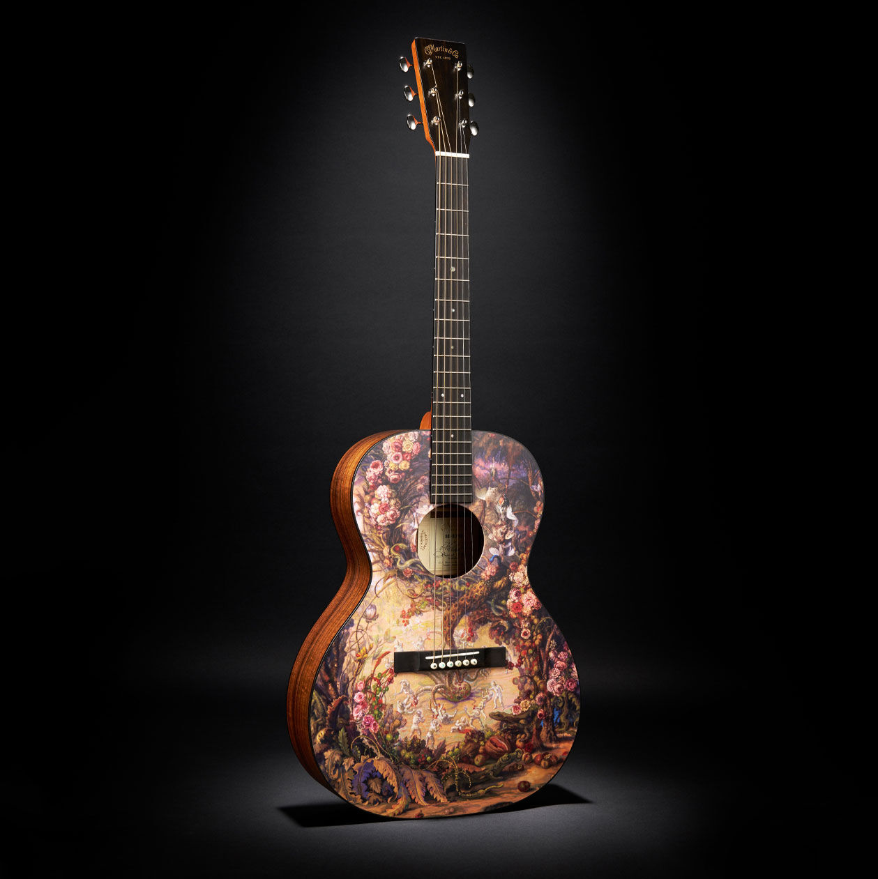 The Martin 00L Oliver acoustic guitar on a black background