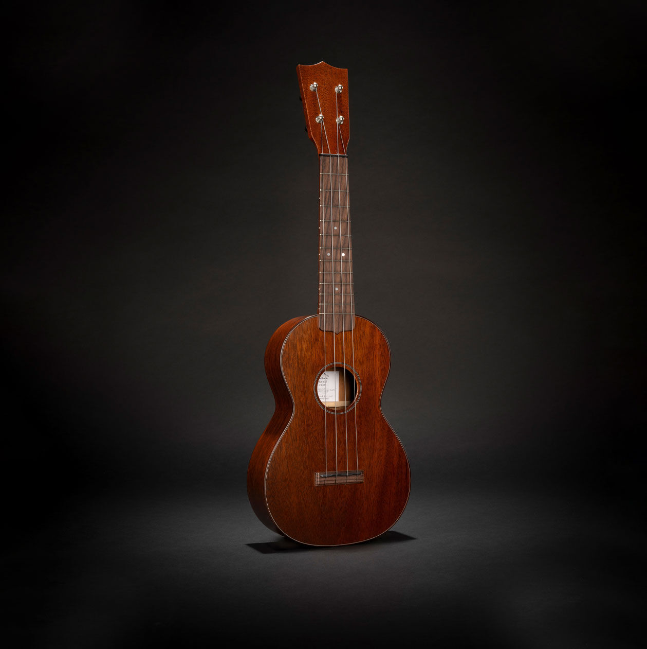 The Martin Centennial 1 concert ukulele on a black background