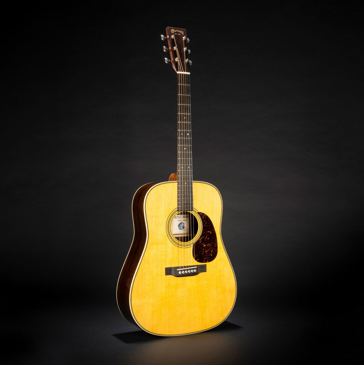 The Martin D-28 Billy Strings acoustic guitar on a black background