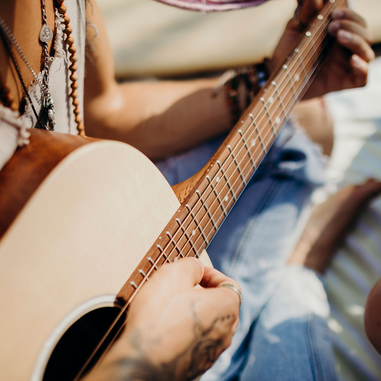 Person playing an acoustic guitar