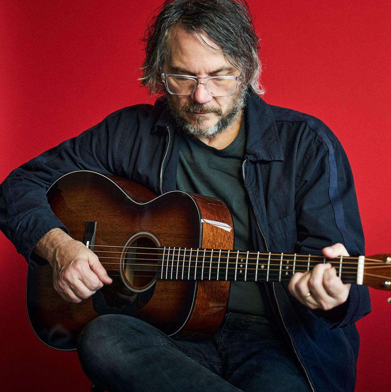 Jeff Tweedy playing his signature acoustic guitar