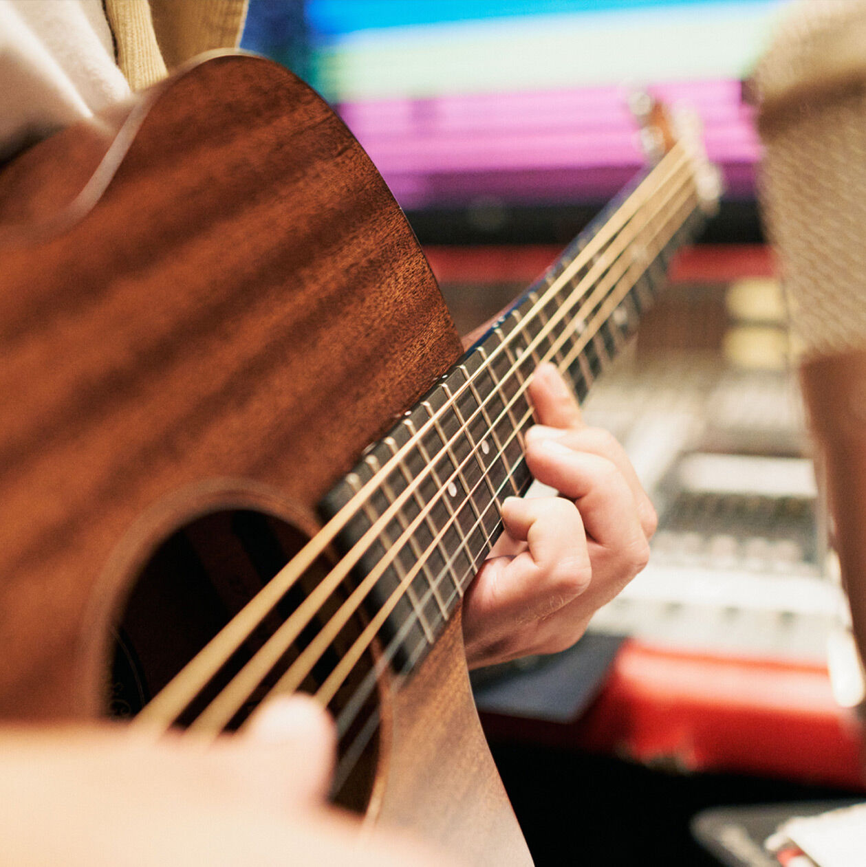 A person playing an acoustic guitar