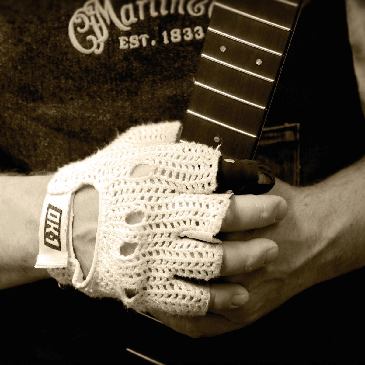 Hands holding a finished guitar