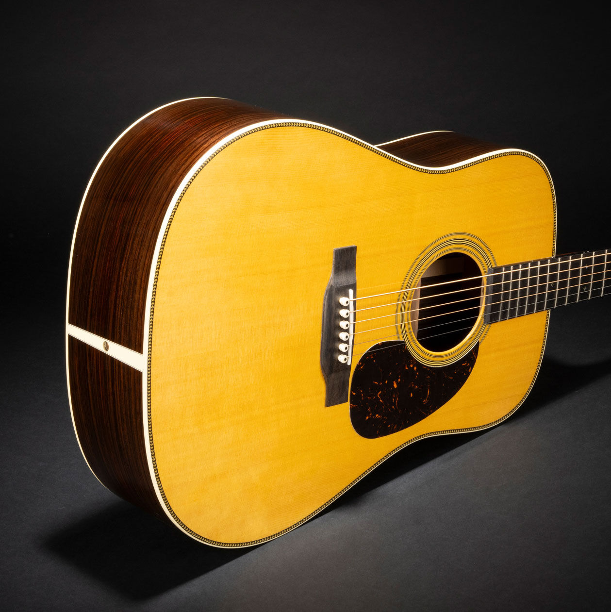 Photo of the D-28 Billy Strings acoustic guitar on its side