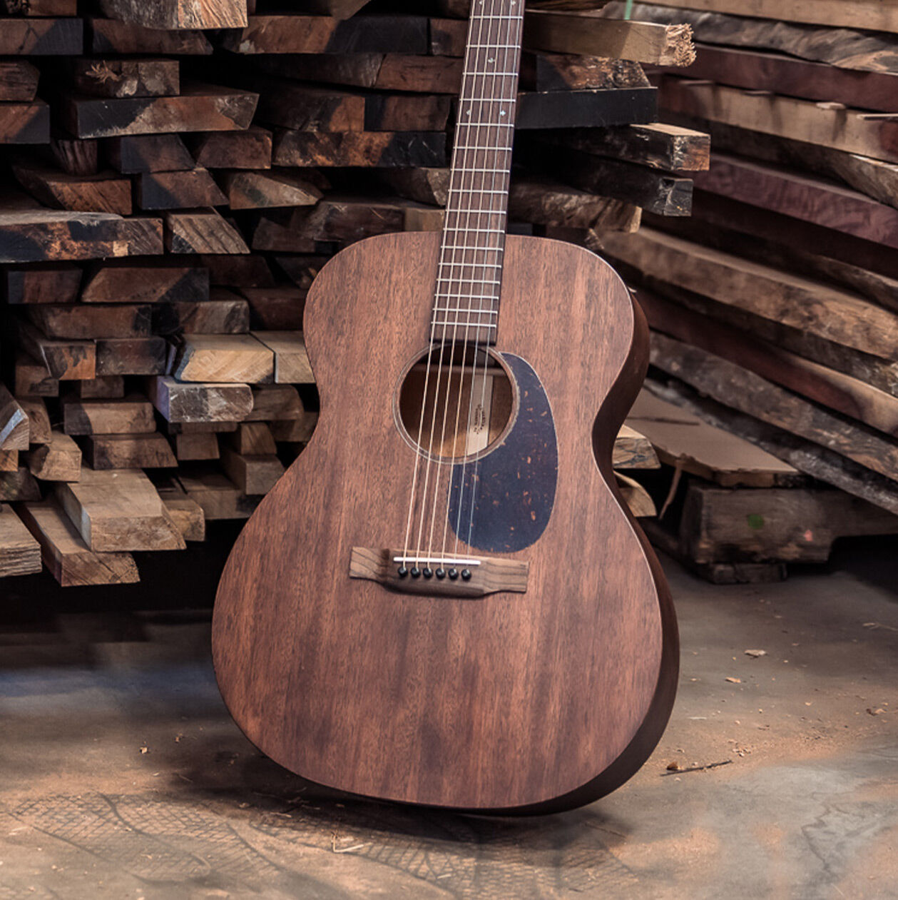 Guitar leaning against lumber pile