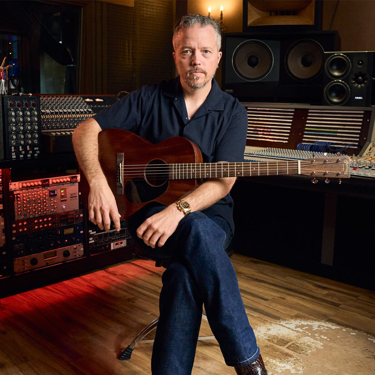 Jason Isbell sitting with his guitar