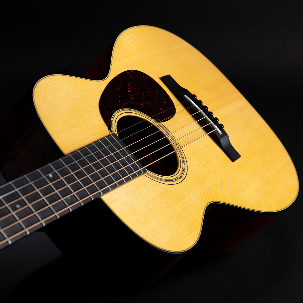 Guitar leaning against lumber pile