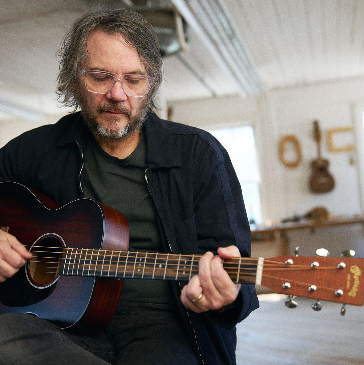 Jeff Tweedy playing his signature acoustic guitar