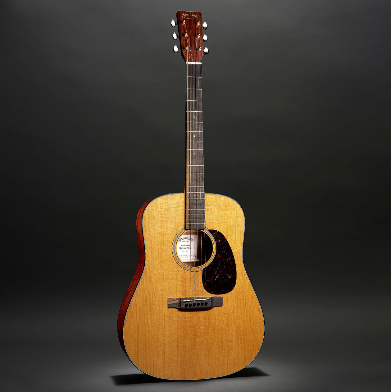 The Martin DE Retro Plus acoustic guitar on a black background