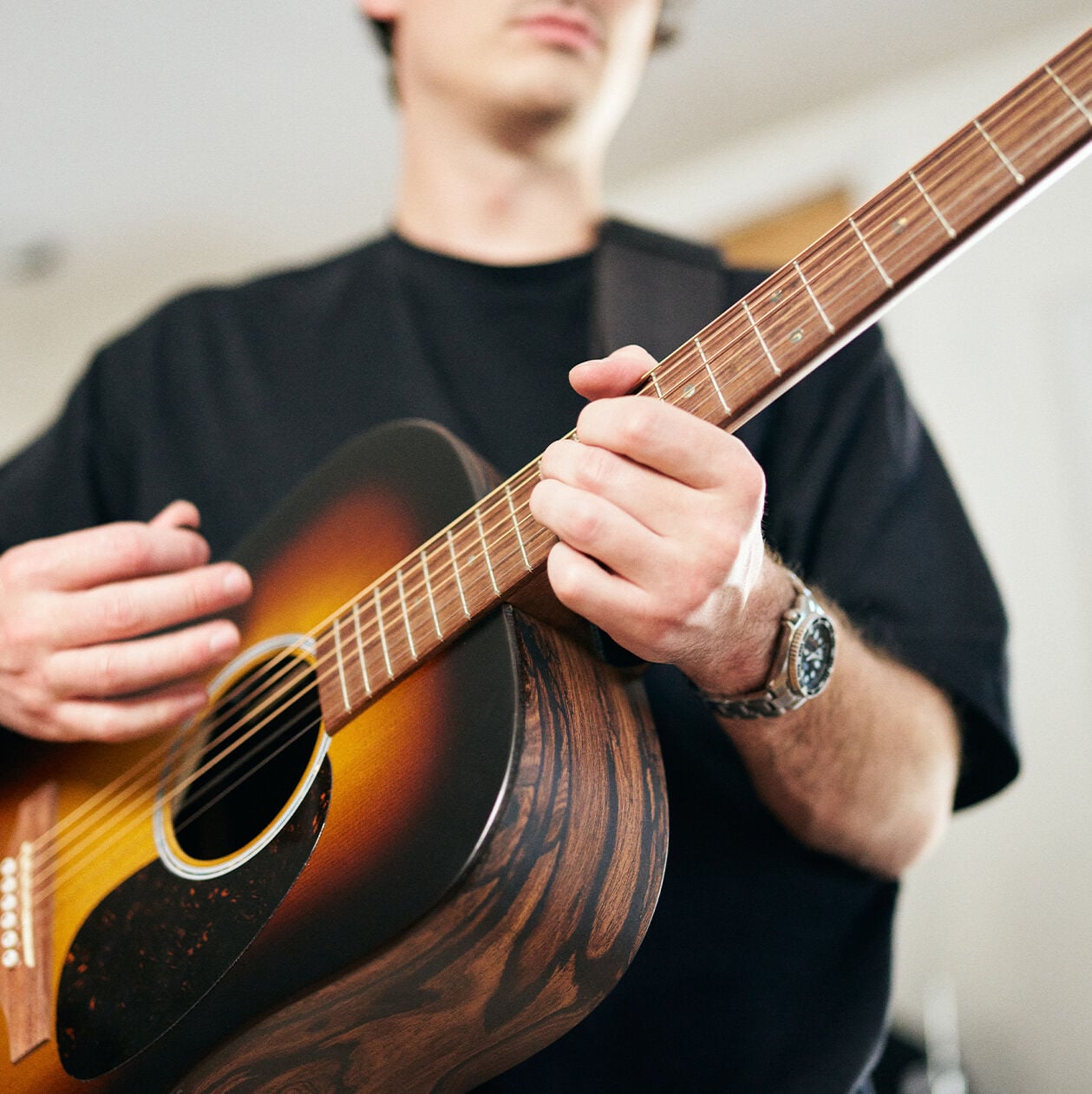 Person playing an acoustic guitar