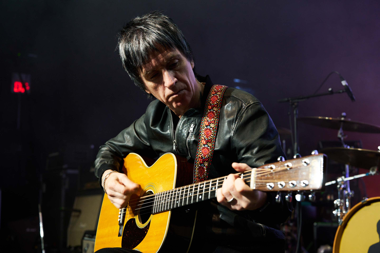 Johnny Marr playing his guitar on stage